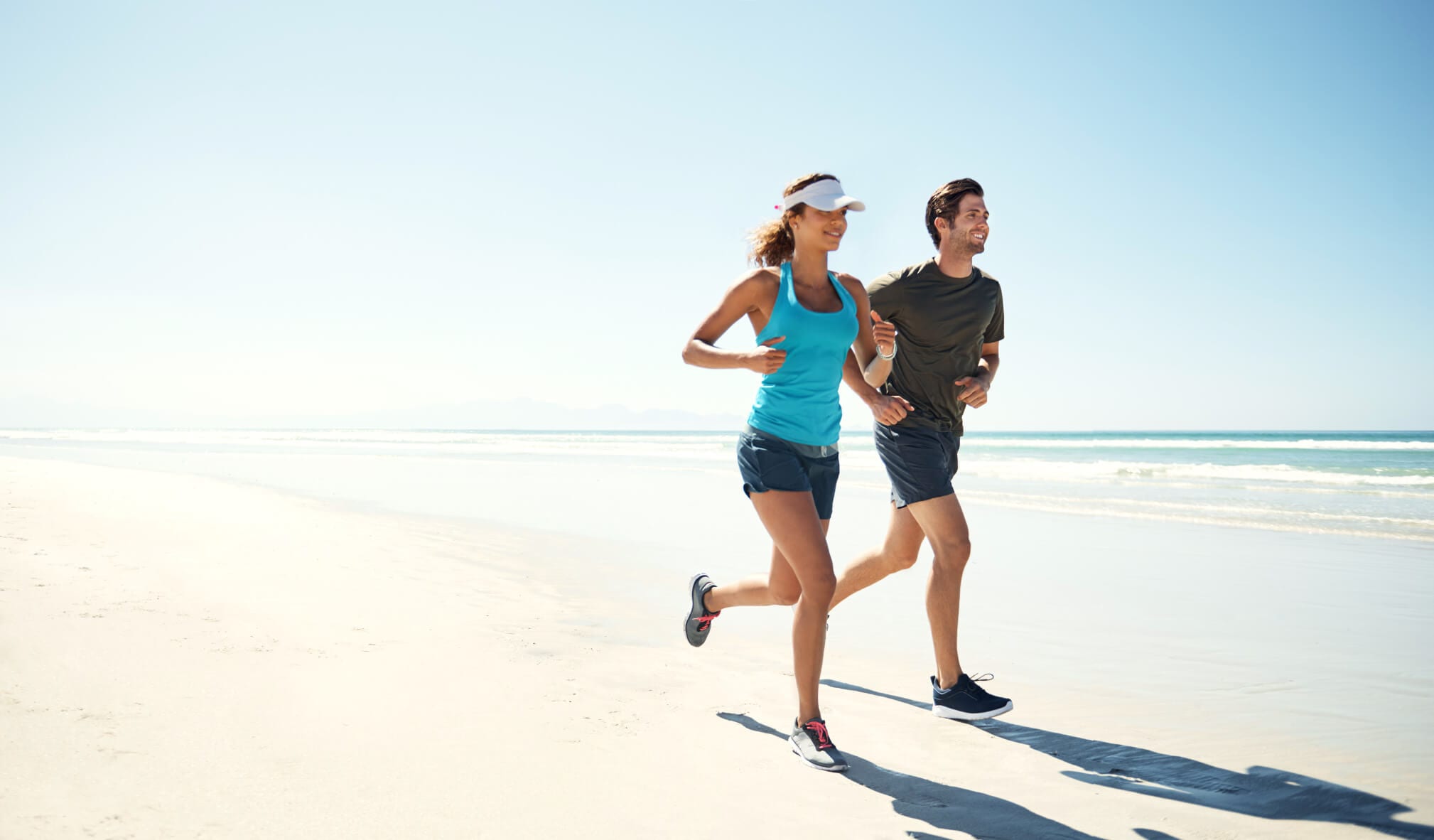 Young couple running on the beach